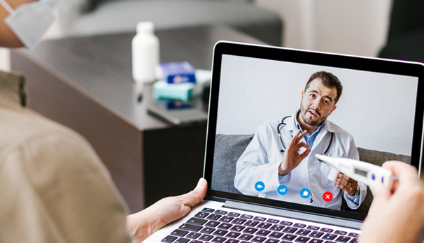 A patient visiting a doctor on computer